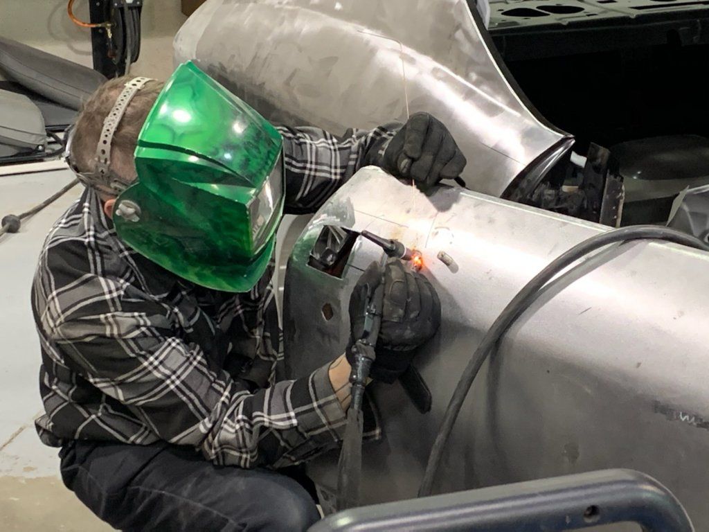 mechanic earing welding mask detailing car