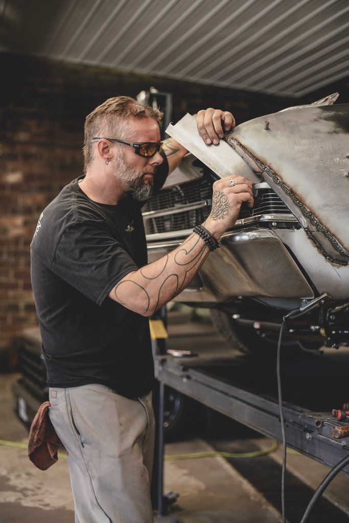 mechanic detailing front of car