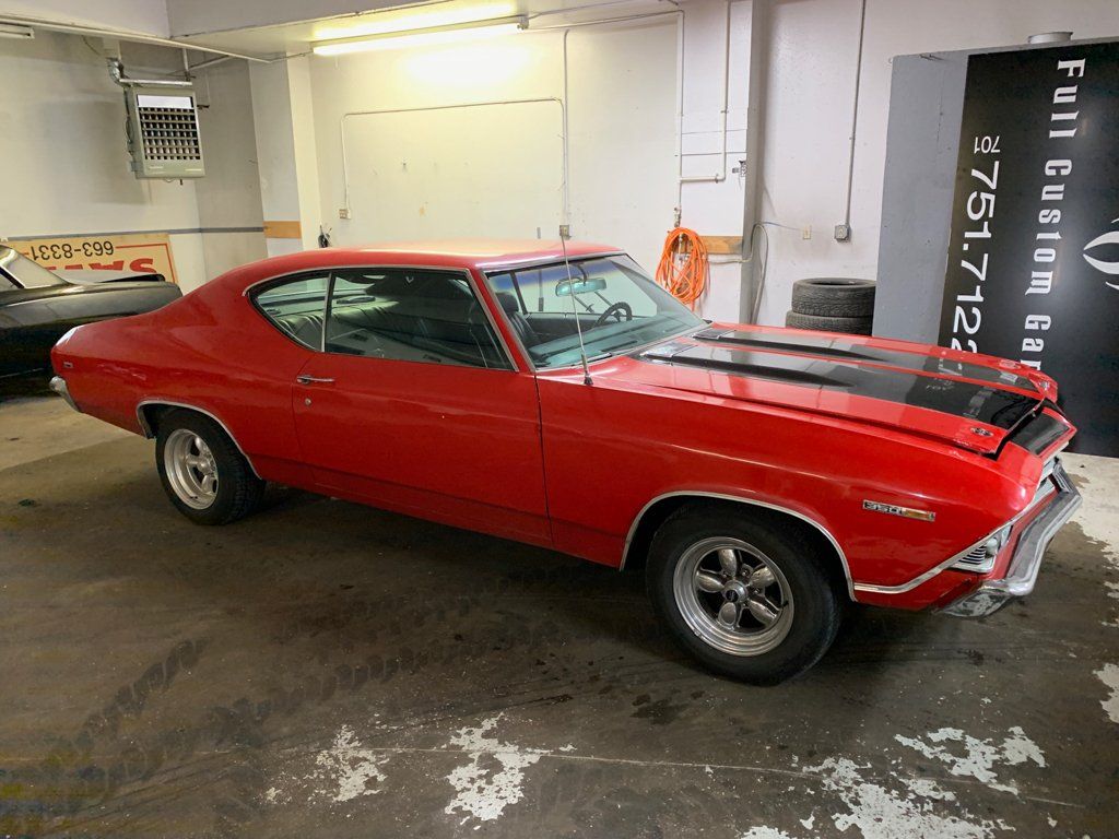 red chevy chevelle inside garage