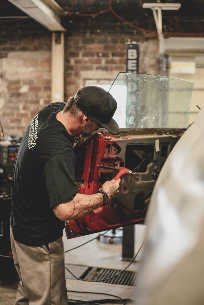 mechanic detailing inside of car door