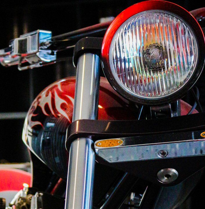 close up view of orange custom motorcycle headlight