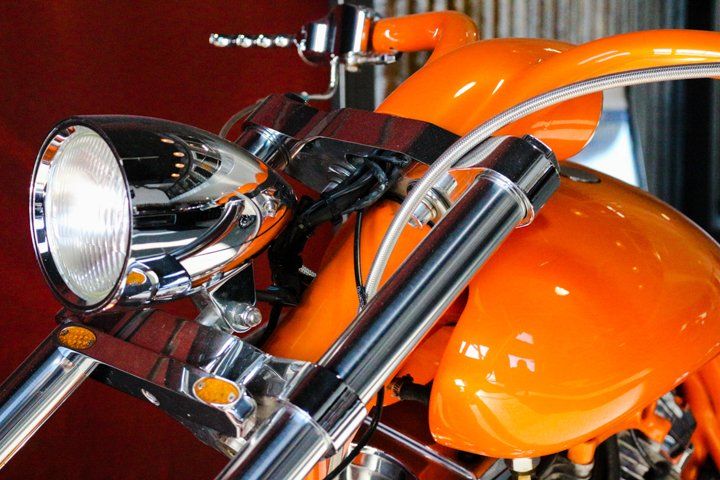 Close up of orange custom motorcycle detail