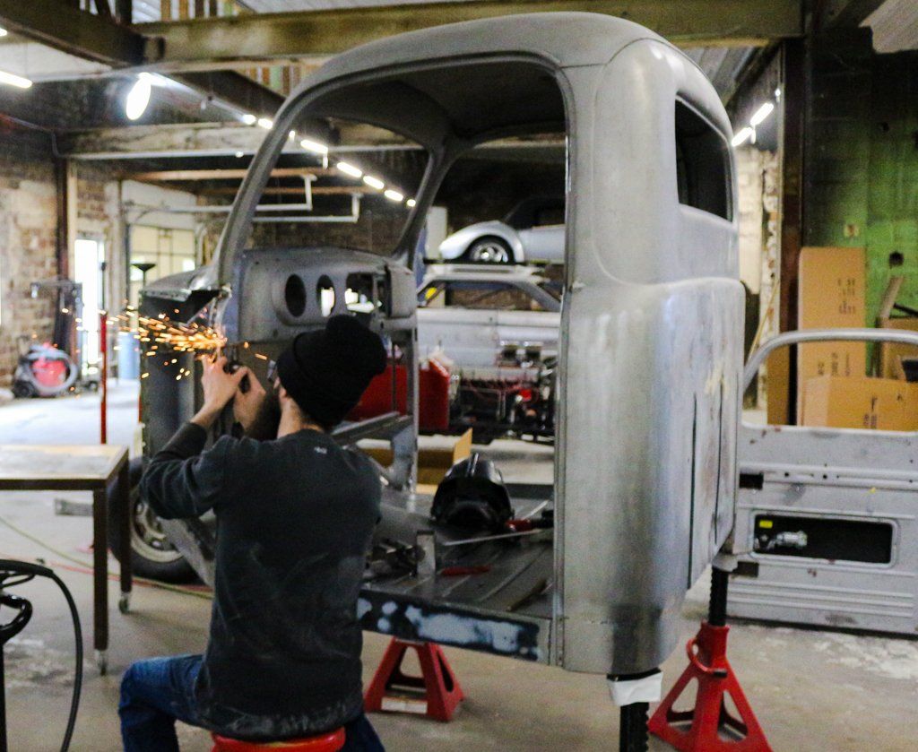 mechanic creating sparks with tool detailing truck frame