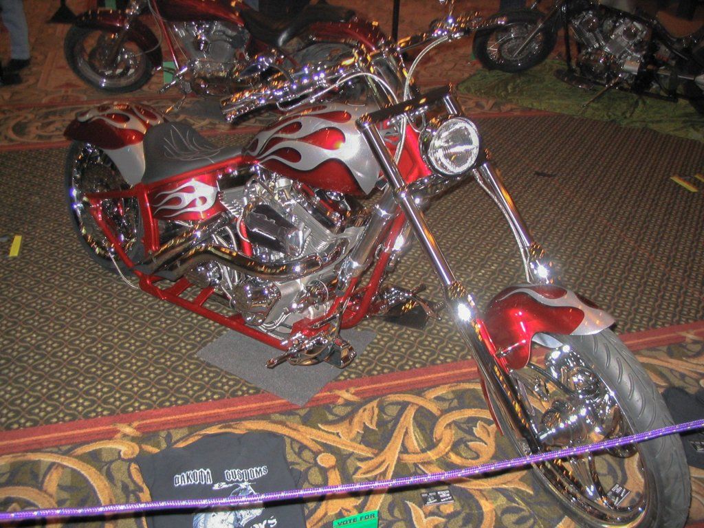 front view of customized red and chrome motorcycle chopper in showcase display
