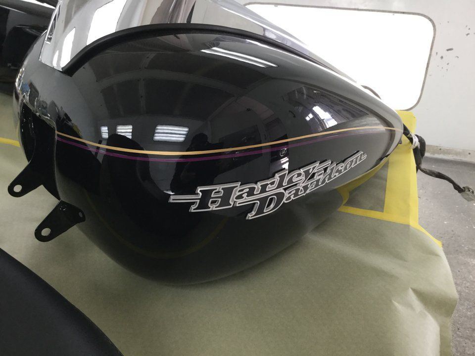 close up of custom striping for black harley davidson motorcycle