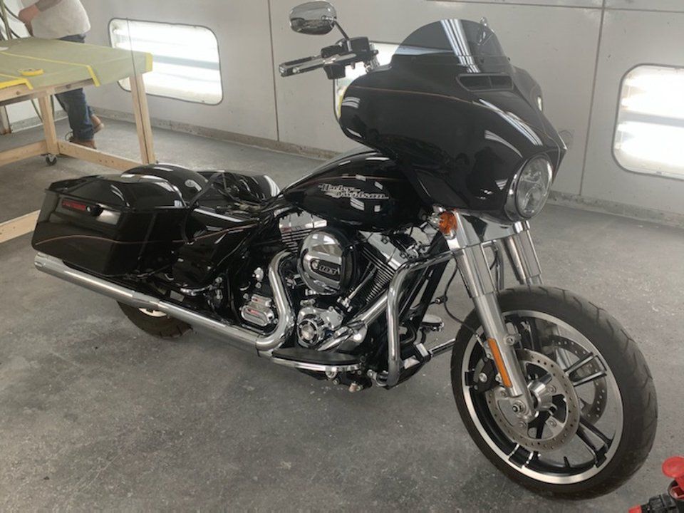 front side view customized black motorcycle with yellow and purple pinstriping