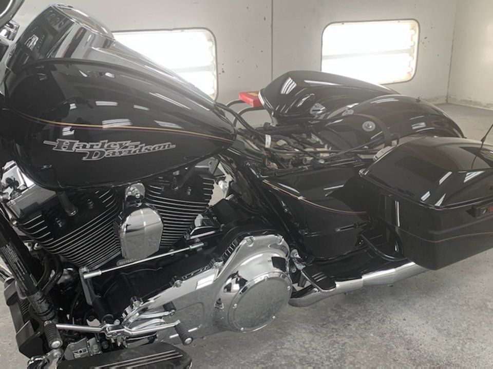 side view of customized black motorcycle with yellow and purple pinstriping