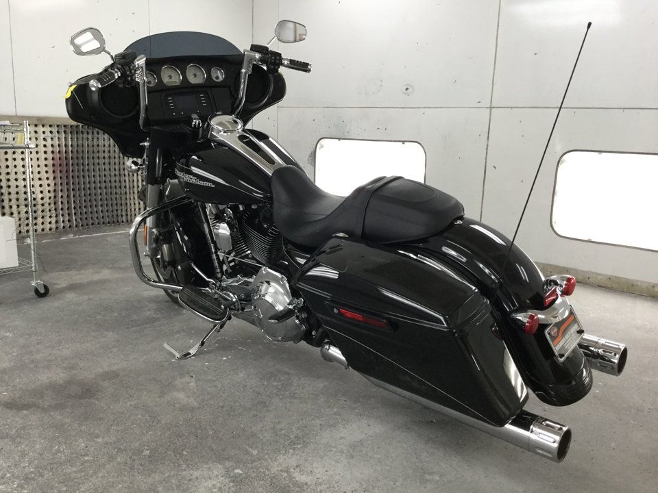 rear side view of black motorcycle before pin-striping