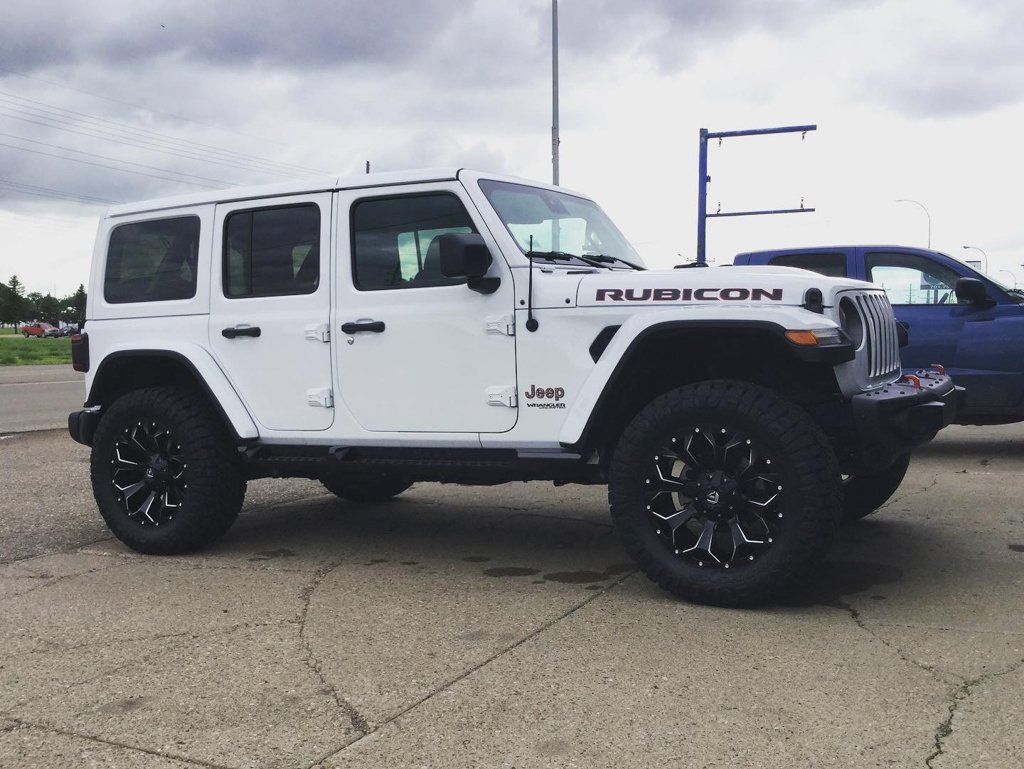 custom white jeep rubicon after shot with lift kit and new wheels