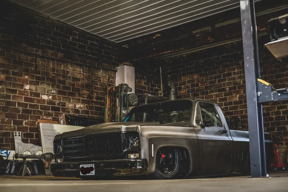 final fully customized truck in corner of brick garage