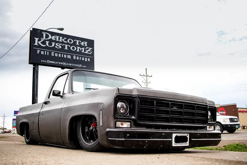 fully customized truck in front of dakota kustomz sign