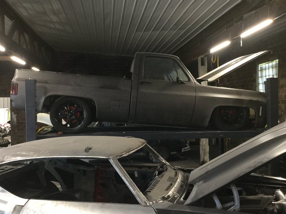 side view of truck suspended on service bay