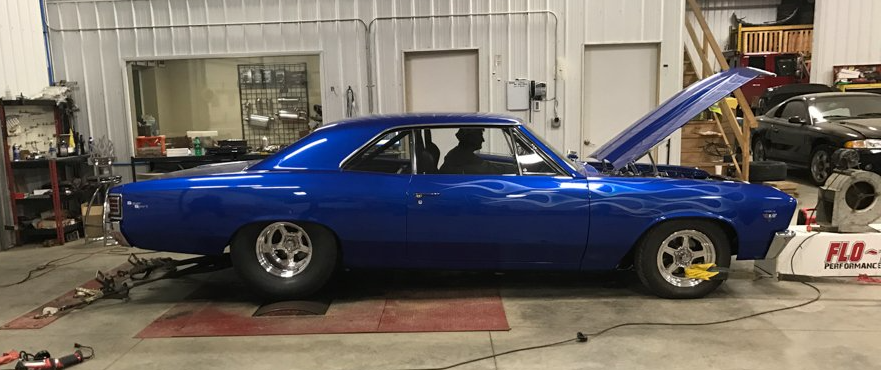 customized blue 1967 flame chevy chevelle muscle car inside service garage