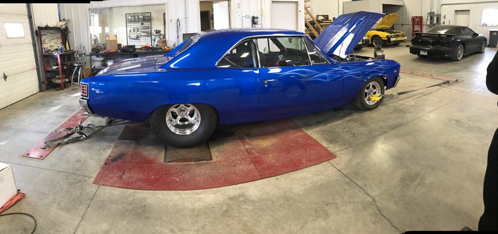 side view of car in garage with hood open