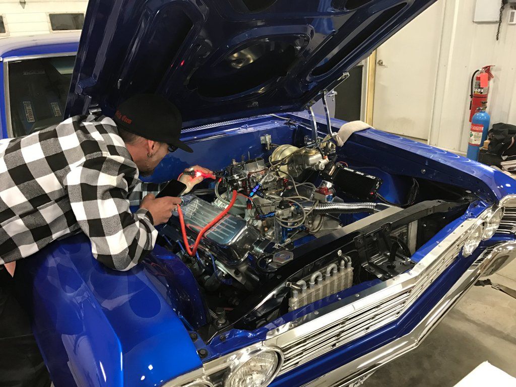 mechanic working on engine of car