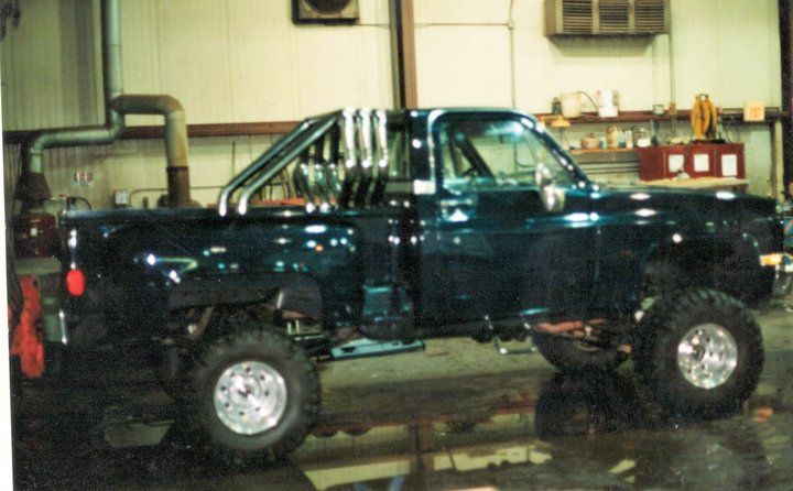 custom black pickup truck with chrome and lift accessories