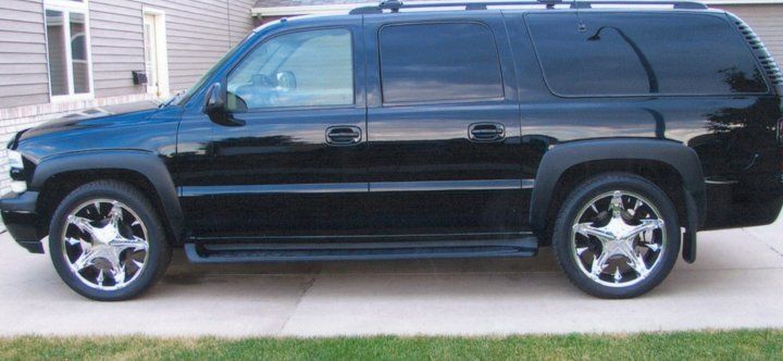 customized black SUV with chrome spike wheels