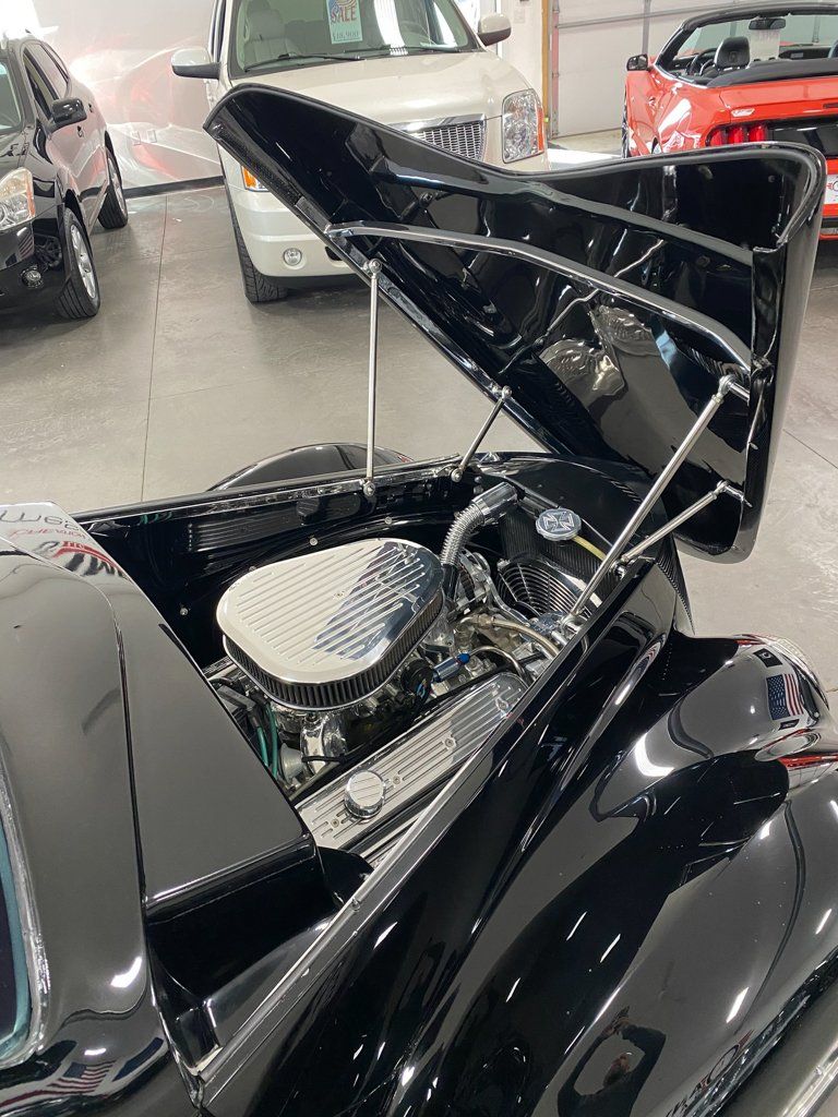 custom black 1937 ford tudor hot rod with hood opened