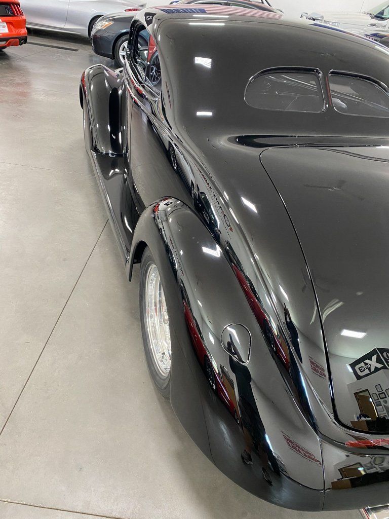 side profile view of custom black 1937 ford tudor hot rod