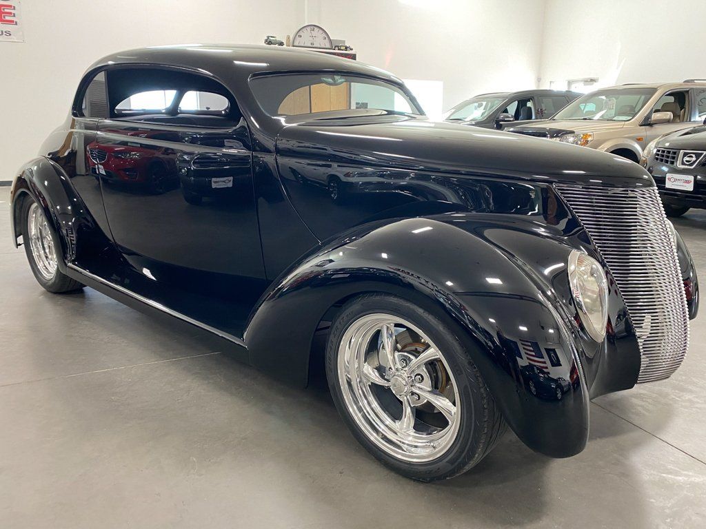 side view of custom black 1937 ford tudor hot rod