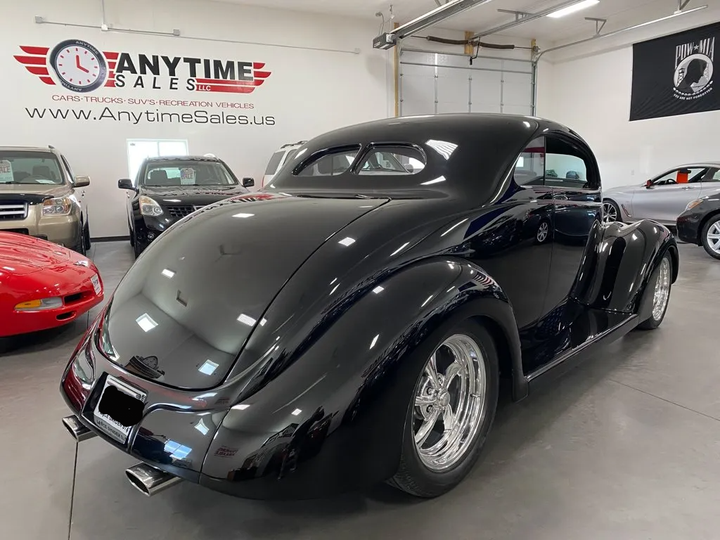 rear view of custom black 1937 ford tudor hot rod