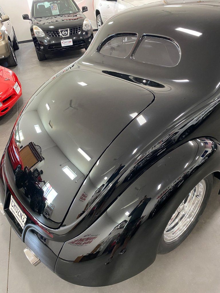 rear view of custom black 1937 ford tudor hot rod