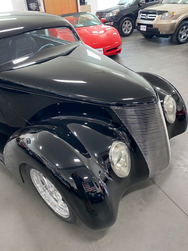 front view of custom black 1937 ford tudor hot rod