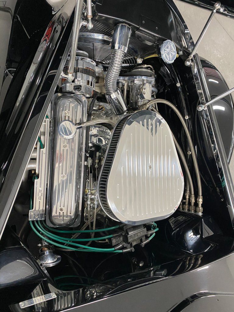 closeup of engine for custom black 1937 ford tudor hot rod