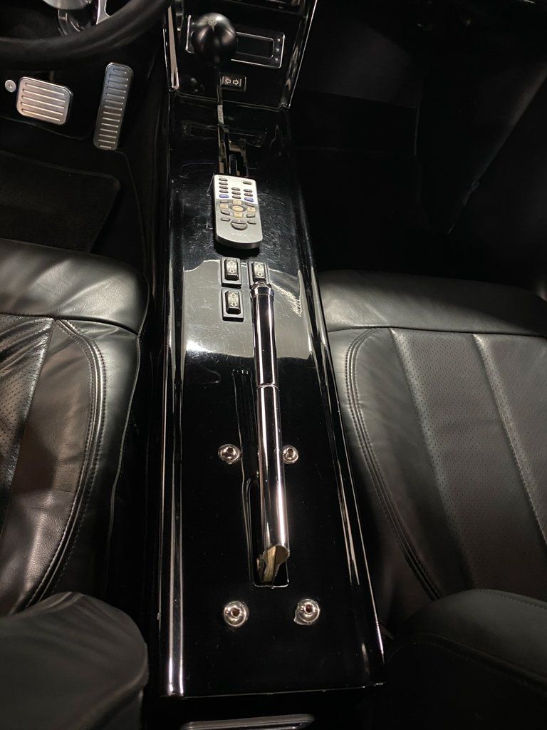 interior view of emergency brake and central console for custom black 1937 ford tudor hot rod