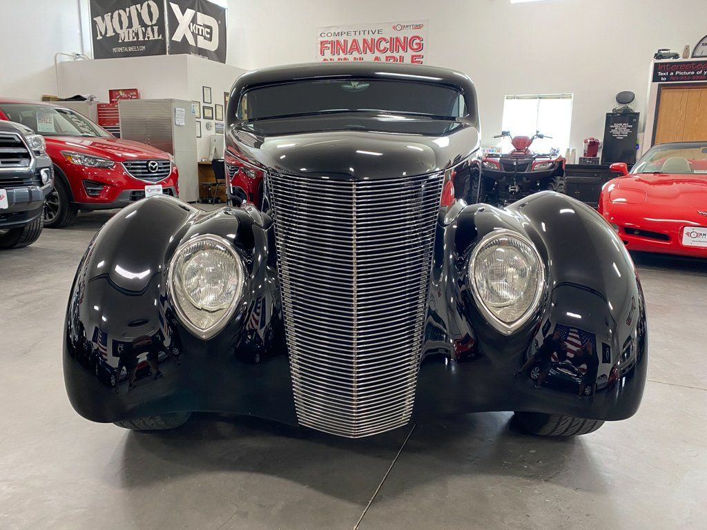 front view of custom black 1937 ford tudor hot rod