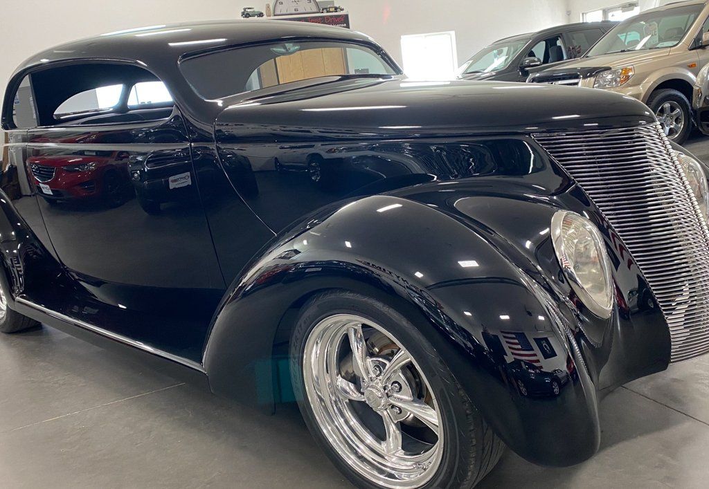 front side view of custom black 1937 ford tudor hot rod