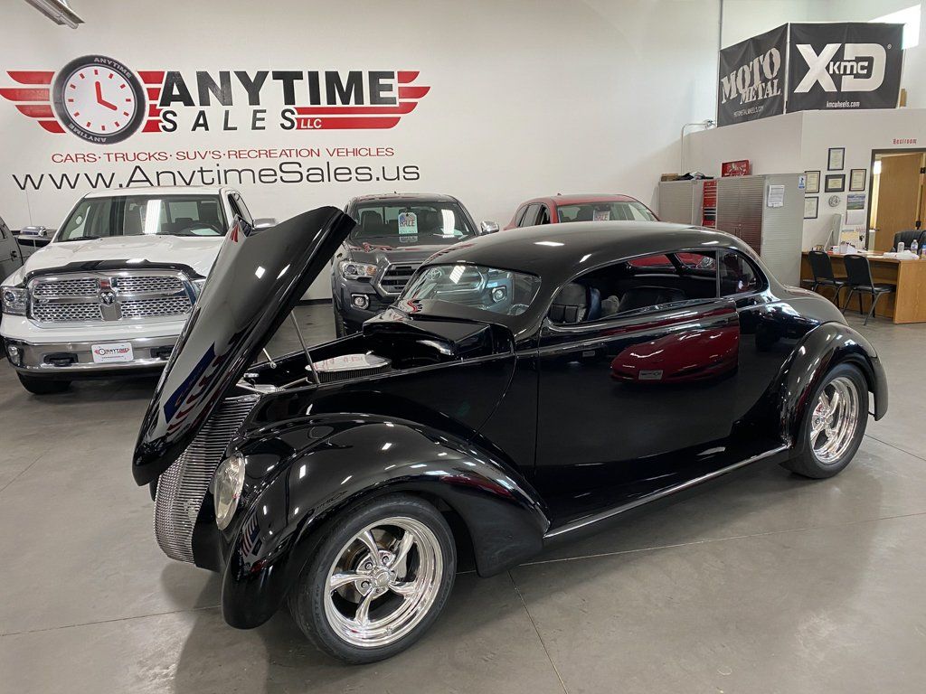customized 1937 black ford tudor front side view with hood open