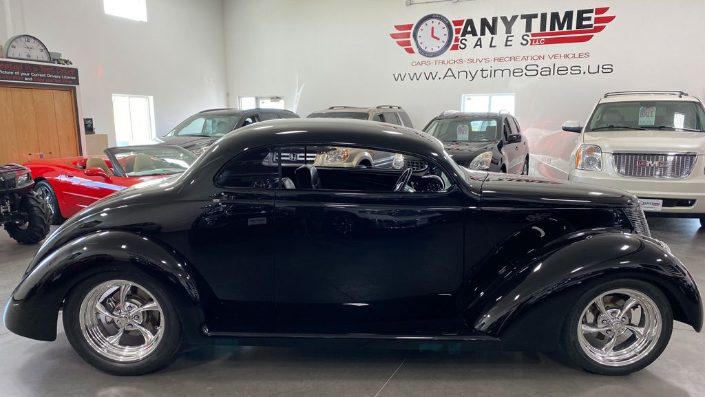 customized 1937 black ford tudor side view