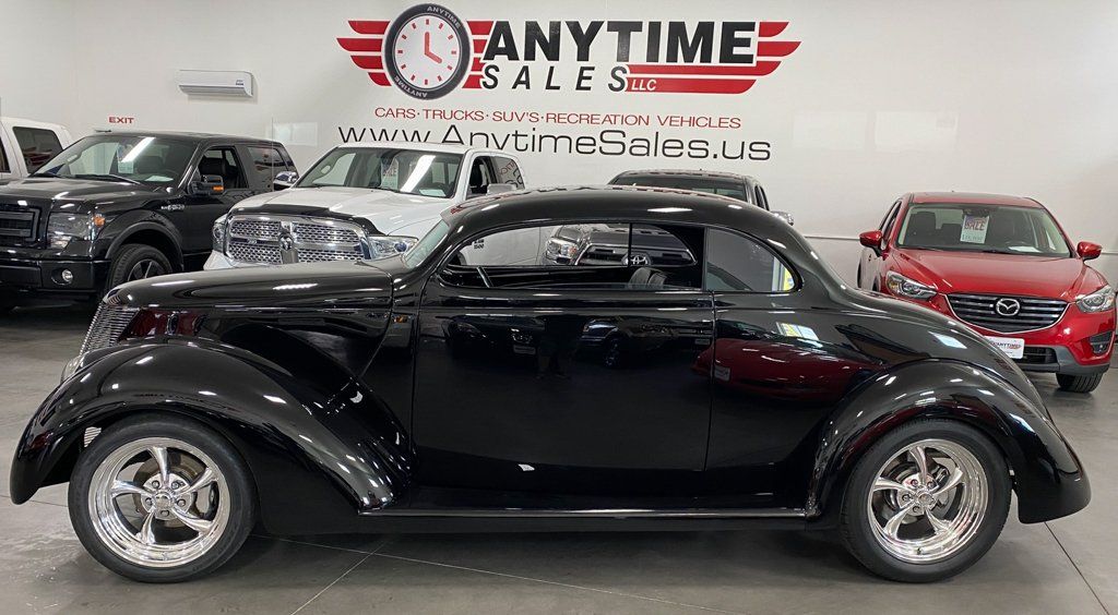 customized 1937 black ford tudor side view