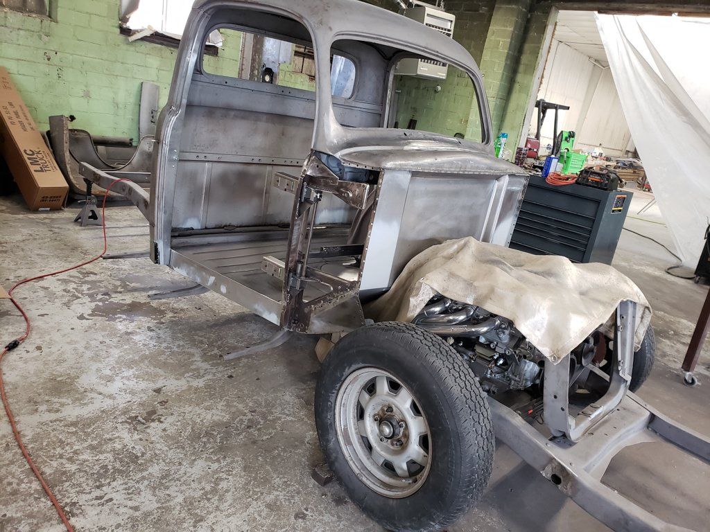 close up of truck frame with cloth over engine
