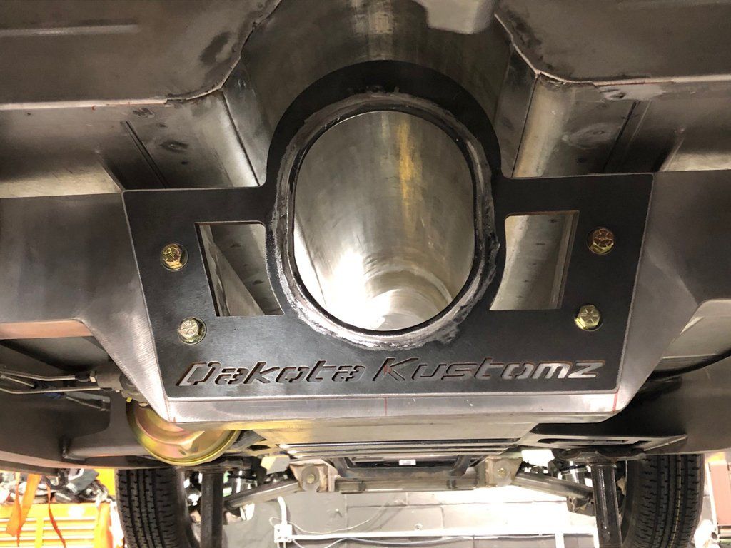close up of dakota kustomz customized exhaust pipe under car