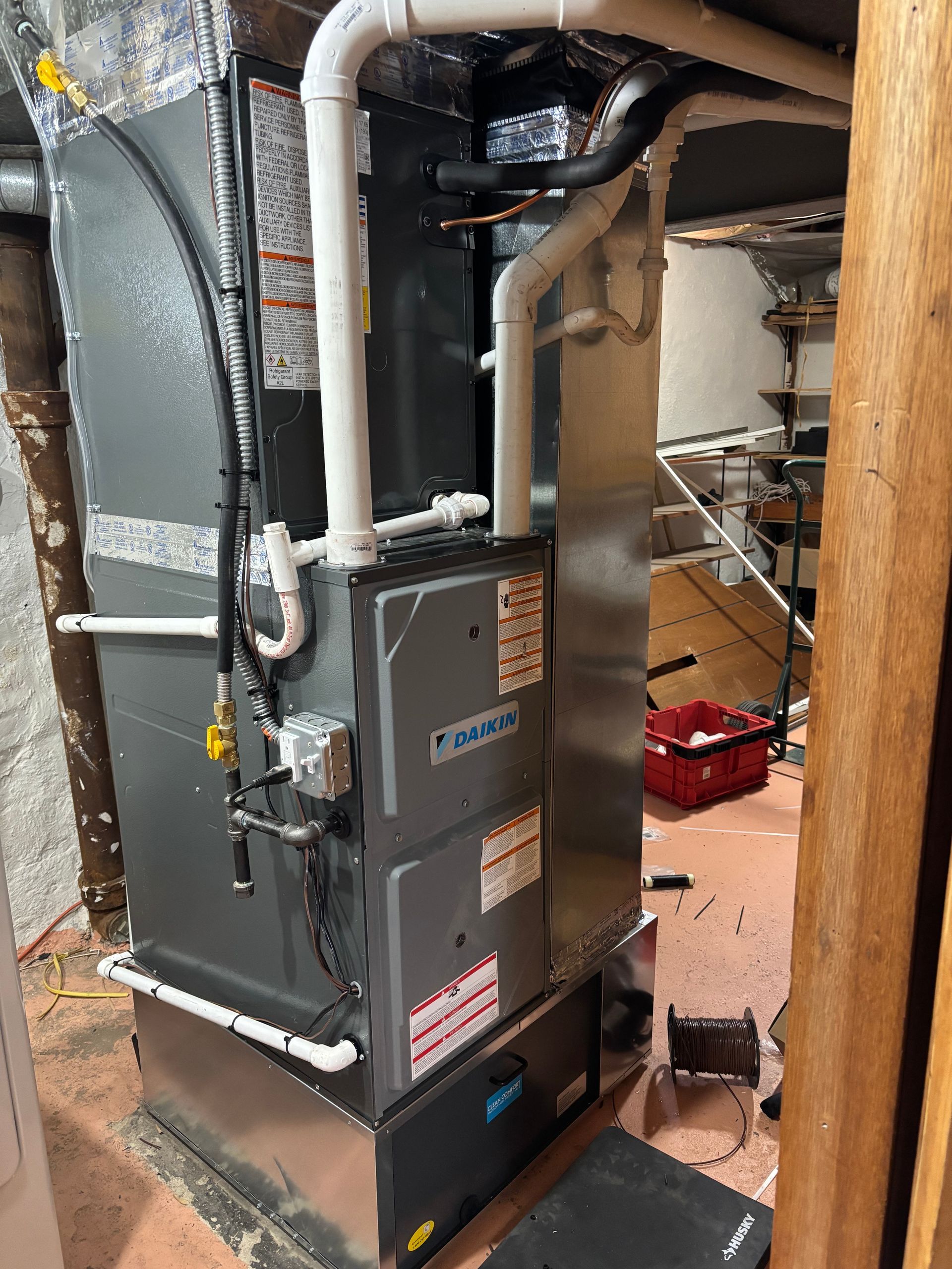 A heating and cooling system is being installed in a basement.