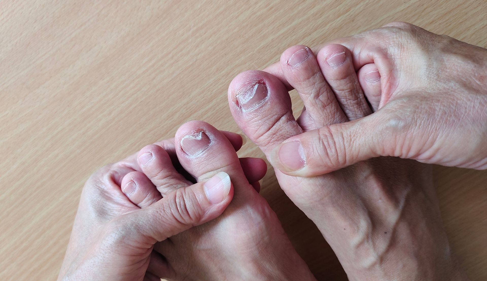 A doctor is using a machine on a patient 's foot.