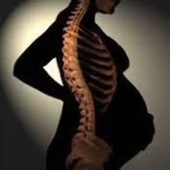 Silhouette of a pregnant person with an overlay of a skeletal spine and rib cage.