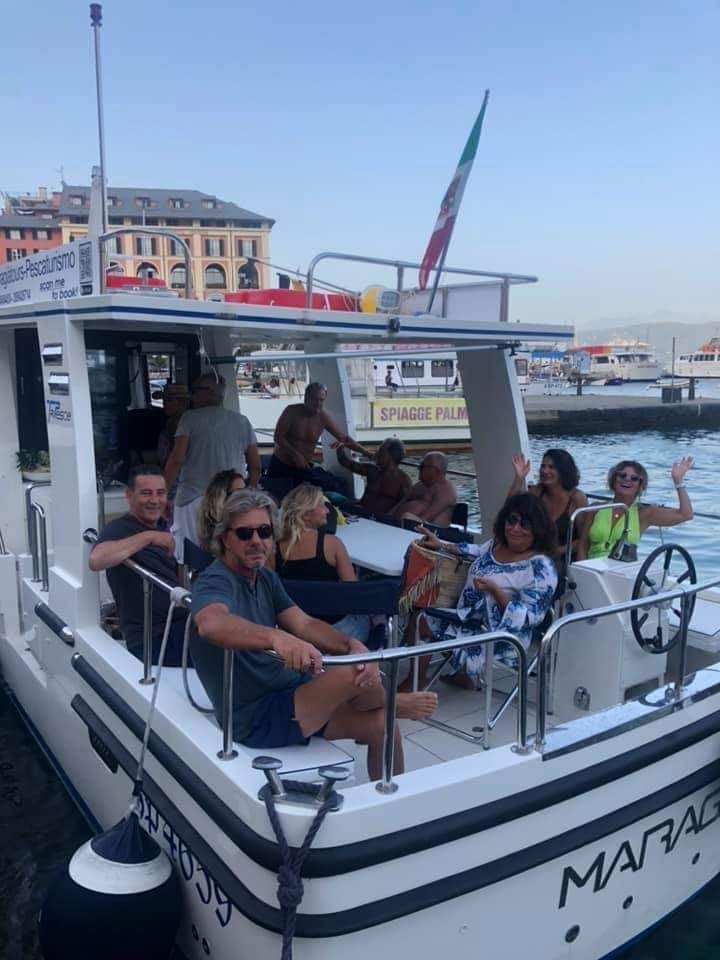 Un gruppo di persone è seduto su una barca in acqua.