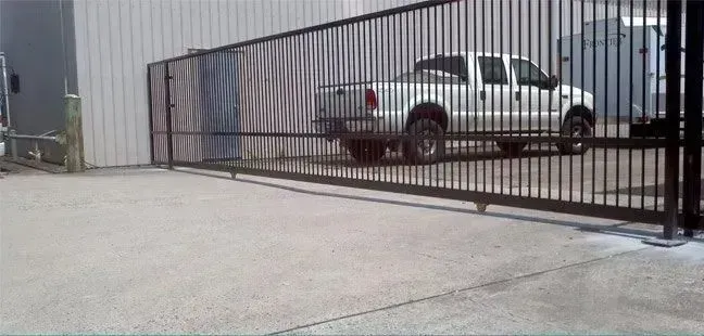 Black commercial security gate installation in Brisbane at an industrial facility