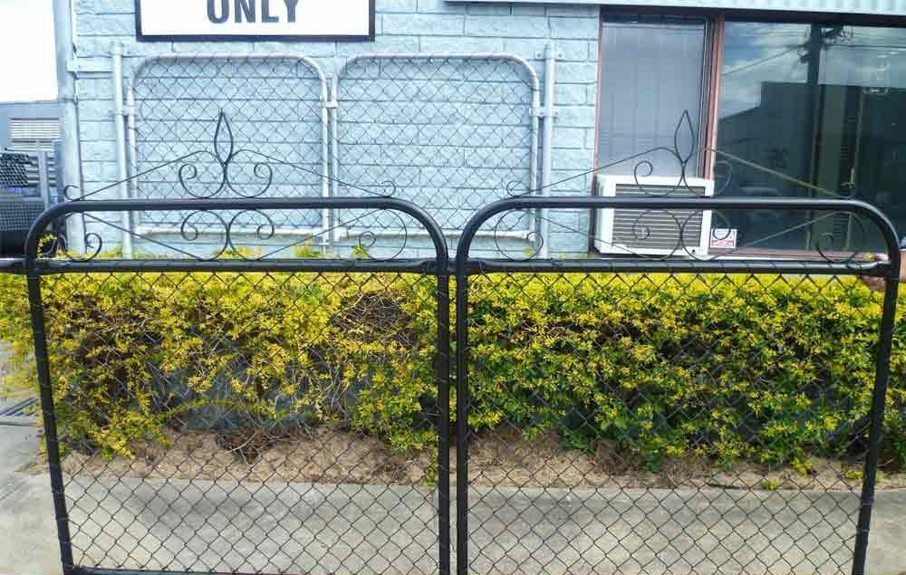 black federation-style heritage gate in Brisbane with decorative scrollwork and chain wire infill