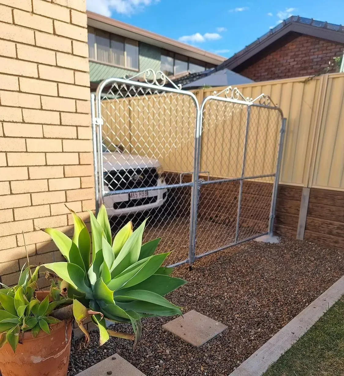 galvanised steel heritage gate with scrollwork detail, installed in a Brisbane residential property driveway