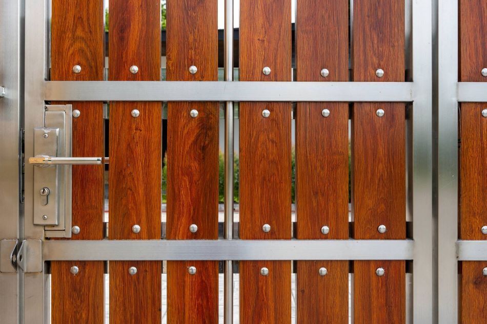 close-up of custom steel gate frame with vertical timber slats for paling gate
