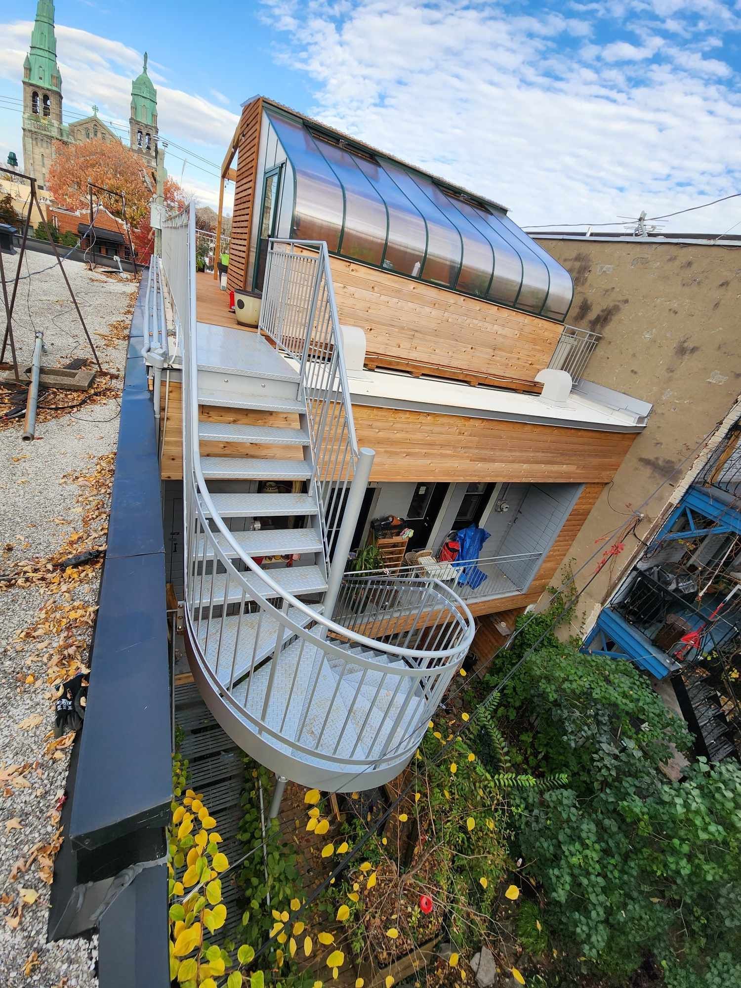 A spiral staircase leading up to the roof of a building