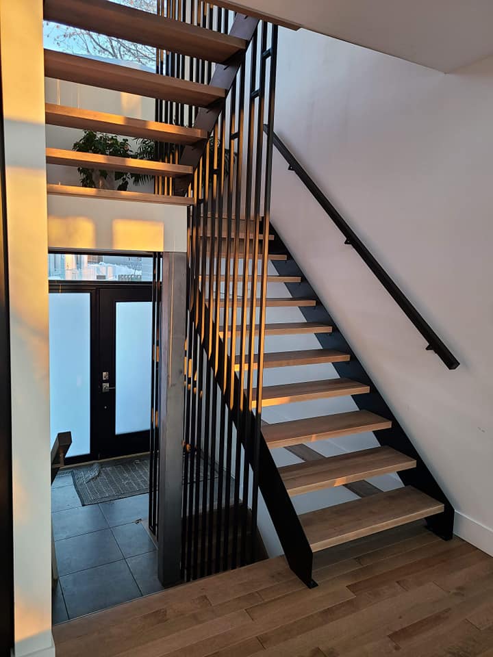 A staircase with wooden steps and a metal railing