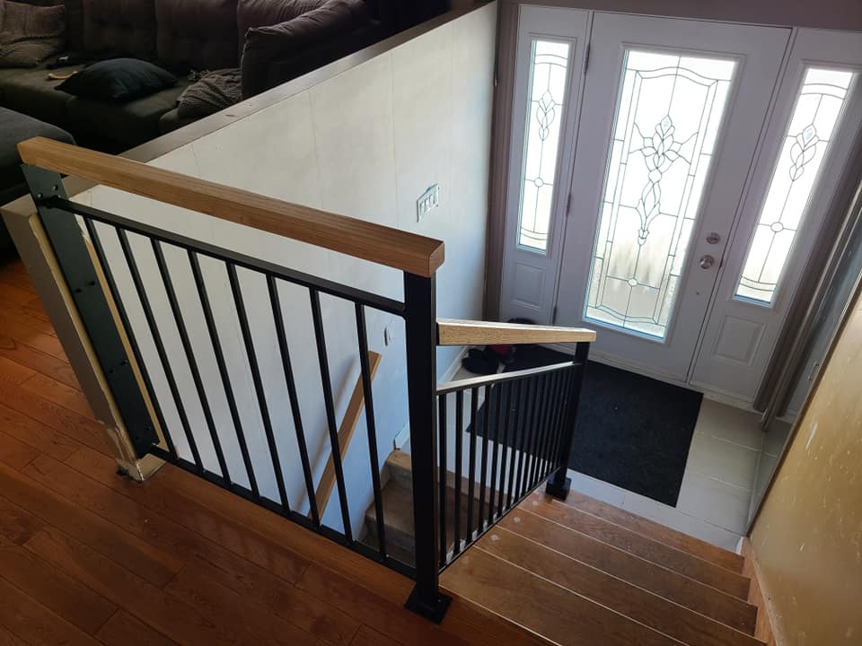 A view of a staircase leading up to a door in a living room.
