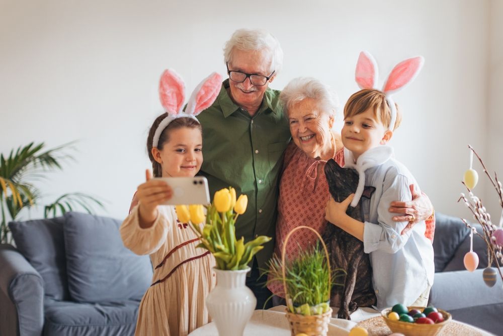 A family is taking a selfie together while wearing bunny ears.