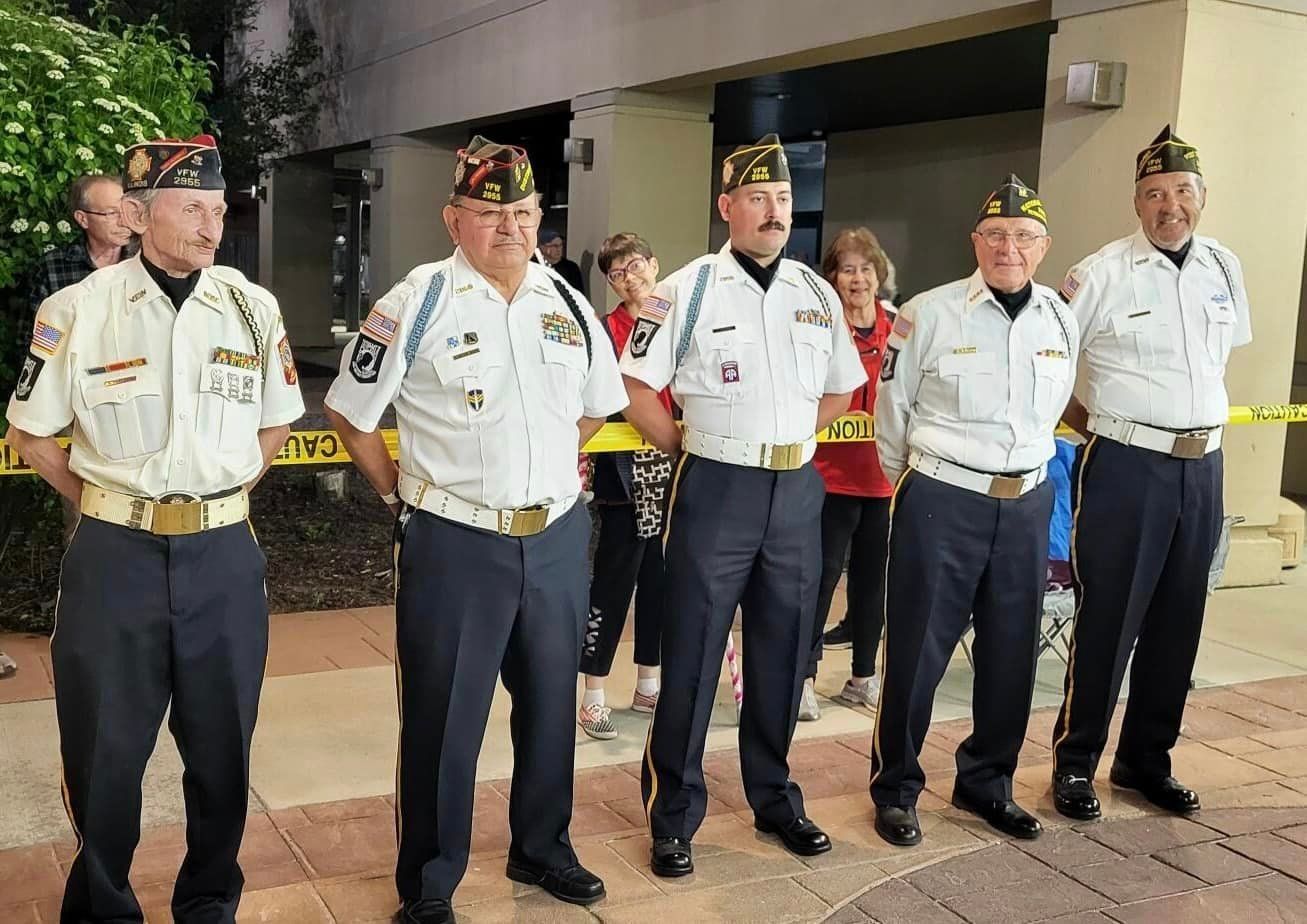 A group of men in military uniforms are standing next to each other.