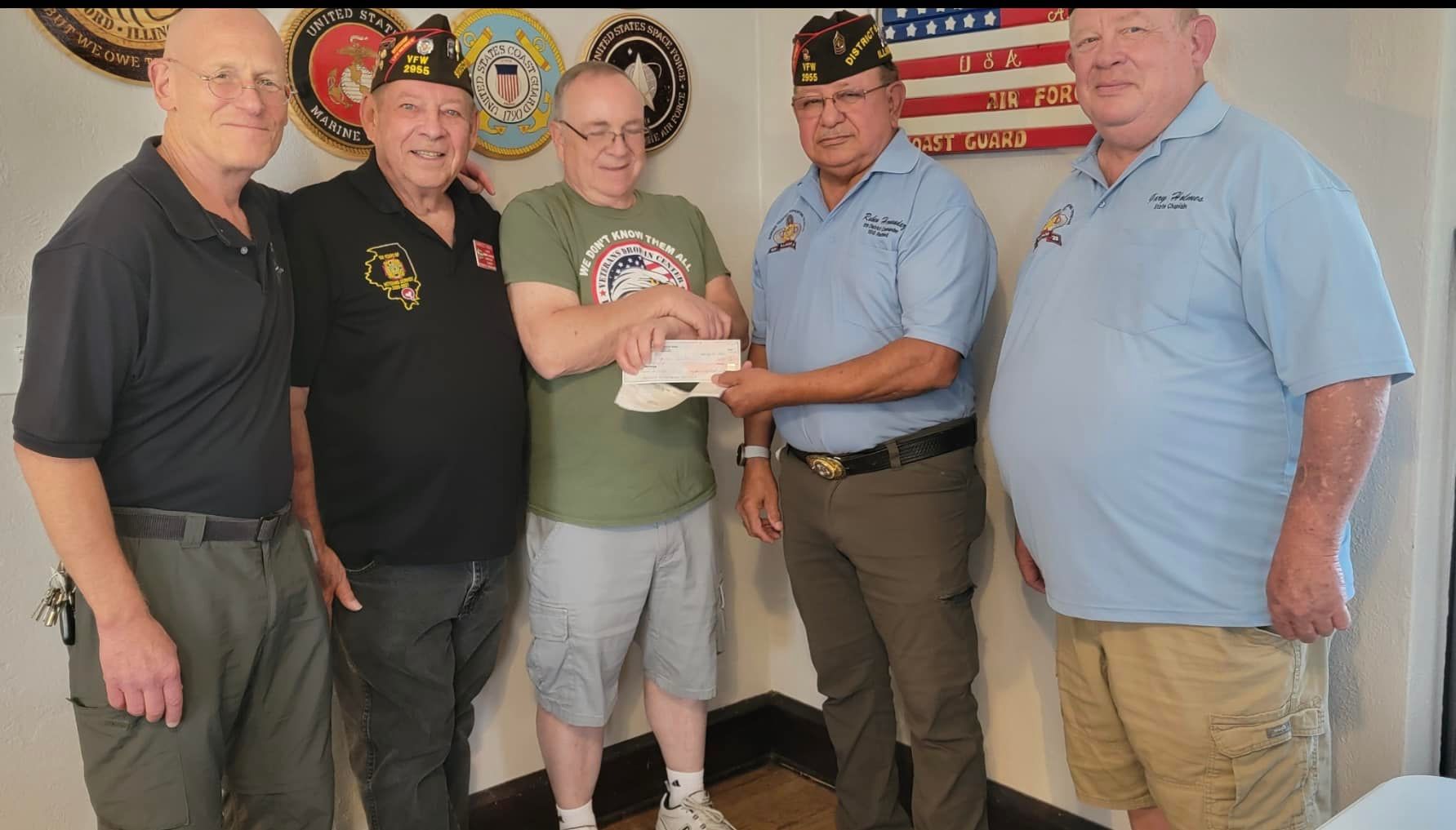 A group of men are standing next to each other in a room.